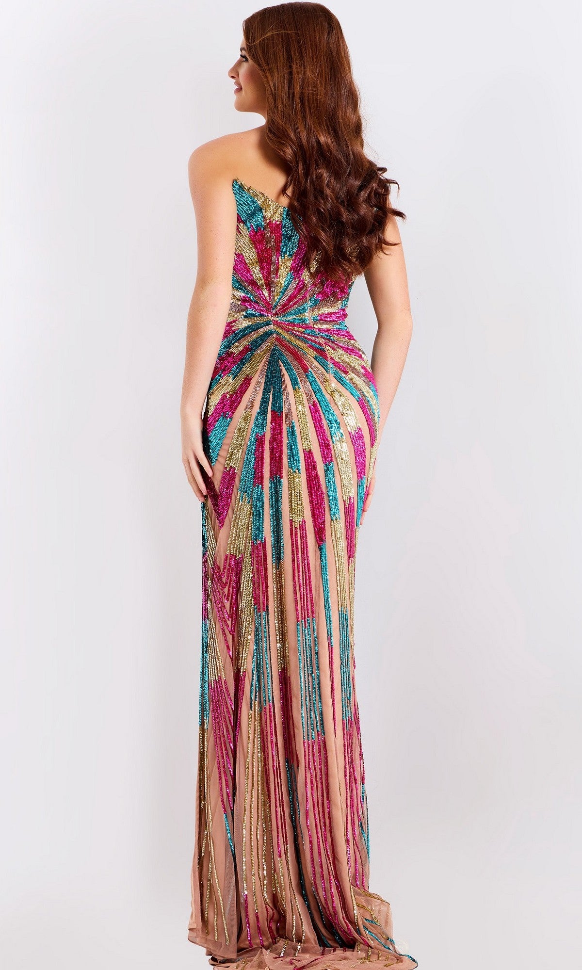 Woman with long, wavy brown hair wears Jovani 47832, a strapless long prom dress with a multicolor sequin beaded geometric pattern, shown from the back.